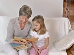 HD DOLLY: Granny Reading Book With Granddaughter Stock Footage