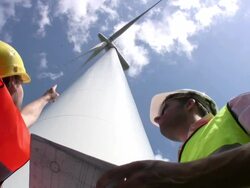 Engineer pointing at wind turbine Stock Footage