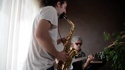 Men playing guitar and saxophone. Stock Footage