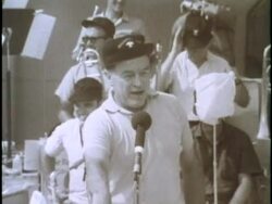 Comedian Bob Hope entertains a crowd of soldiers U.S. sailors at a USO show aboard the USS Ticonderoga. News Clip
