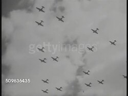 1940: US AIR CORPS: AERIAL TU Vultee BT-13 airplane in flight. TU WS Silhouette of many single engine airplanes in flight. HA EXT Navy Department building. Four unidentified man in meeting. CU Report cover 'Influence of Sea Power Upon History' Instructional Video