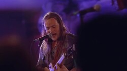 Musician sings and plays guitar on stage at a crowded South By Southwest gig Stock Footage