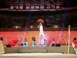 MS View of Some people performing tightrope walking with paper fan andothers playing Korean traditional musical instruments against Heungnyemun gate(Traditional Korean Architecture) of Kyongbokkung Palace AUDIO  / Seoul, South Korea Stock Footage