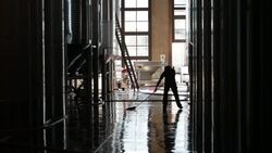 Worker mops floor at Septima winery Stock Footage