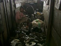 WS View of men breaking up metal components / Lagos, Nigeria Stock Footage