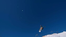 SLO MO Snowboarder jumping over kicker in snowpark Stock Footage