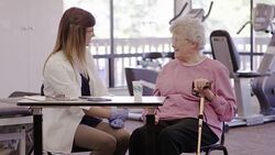 Speech therapist working with a geriatric patient in a clinic Stock Footage