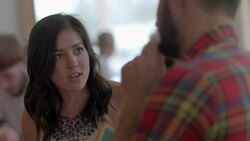 Young woman chats with friend in restaurant Stock Footage