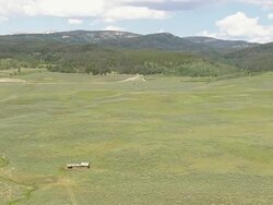WS AERIAL ZI Shot of lone abandoned homestead on landscape / Wyoming, United States Stock Footage