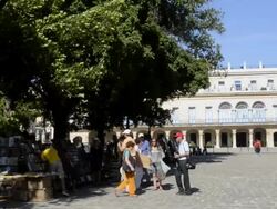 Books on Communism for sale in Plaza de Armas in center plaza of Havana Cuba with tourists Stock Footage