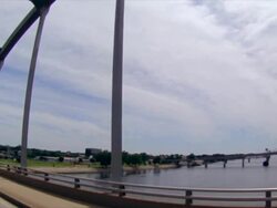 Drive across trestle bridge over Arkansas River with Welcome to North Little Rock sign Stock Footage