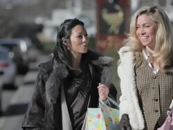 Female friends walking with shopping bags Stock Footage