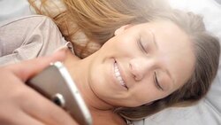 People waking up - Young Woman Texting in Bed Stock Footage