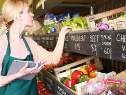 Female shop owner calculating computer tablet Stock Footage