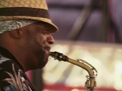 A busker playing a saxophone in time square.  Close up shots of this hands playing the sax. Stock Footage
