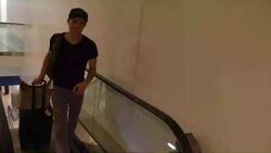 Paul Wesley departing at LAX Airport talking about germs on airplanes in Los Angeles Stock Footage