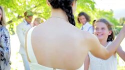 Bridesmaid and flower girl dancing at wedding reception in backyard Stock Footage