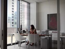 WS businesswoman sitting at desk in office looking out window/Seattle, Washington, USA Stock Footage