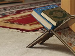 A book of the Koran on a book holder Stock Footage