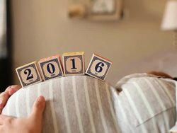 A pregnant women using blocks to spell the word 2016 on her stomach. Stock Footage