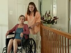 Nurse Assisting Wheelchair Bound Female in Home Stock Footage