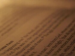 Detailed extreme close-up of a cross being placed on a bible. - Model Released - 1920x1080 - HD Stock Footage