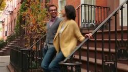 New York couple walk hand-in-hand down steps and away from brownstone apartment (dolly-shot) Stock Footage