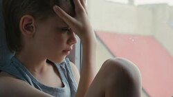 boy sitting at home by the window Stock Footage