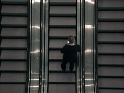 DA Businessman riding up one of three escalators as he is looking at his cell phone / Seattle, Washington, United States Stock Footage