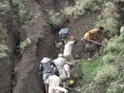 People climbing river bank after crossing river following bridge collapse Stock Footage