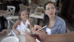 Waiter taking the order of a lovely family at a restaurant Stock Footage