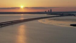 Sunset over Mobile Bay, Alabama, with distant view of skyline. Stock Footage