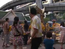 Shrine and People Praying in Thailand News Clip