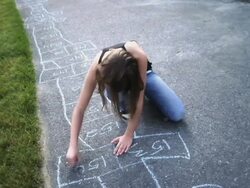 WS Girl drawing hopscotch with colored chalk on sidewalk / Langley, British Columbia, Canada.  Stock Footage
