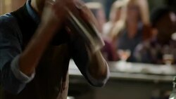 Bartender shakes cocktail shaker with both hands in crowded bar Stock Footage