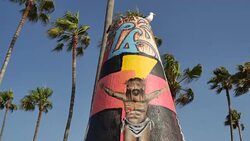 Graffiti covers the Public Art Walls, surrounded by palm trees, near the beach at the Pacific Ocean in Venice, California Stock Footage