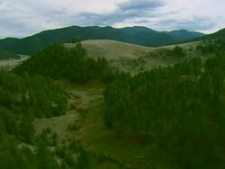 Low altitude forward POV aerial of rolling foothills of the Spanish Peaks mountain range near Bozeman, MT Stock Footage