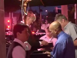 T Bone Burnett & Callie Khouri departing Craigs in West Hollywood Stock Footage