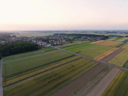 AERIAL Village With Surrounding Fields Stock Footage
