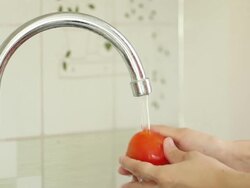 Hands washing tomato Stock Footage