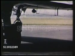 1950: AIRPLANE TAXIING: COLOR: MS Tires, rubber wheels, of unidentifiable aircraft taxiing on runway at airport. Instructional Video