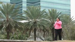 Heavy Hispanic woman power walking with hand weights Stock Footage