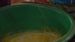 Stiff yellow threads unwind from a bowl. Stock Footage