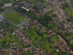 MS AERIAL Shot of houses rooftops and street with railway tracks at Gerstungen / Germany Stock Footage