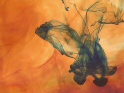 Orange dye dissolving Stock Footage
