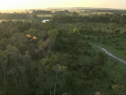 Aerial wooded area with small stream, with audio of hot air balloon, Kenya, Africa (With audio of hot air balloon) Stock Footage