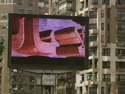 WS View of big television screen outdoors showing advertising with apartments / Cairo, Egypt Stock Footage