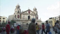 Pedestrians and street vendors crowd a plaza in front of a church. Stock Footage