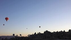 hot air balloons in the air from within the valley in Cappadocia Stock Footage