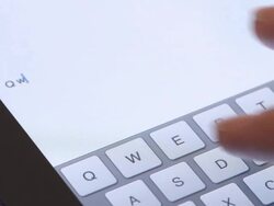 ECU fingers type word Qwerty into virtual keyboard of iPad tablet computer  Stock Footage